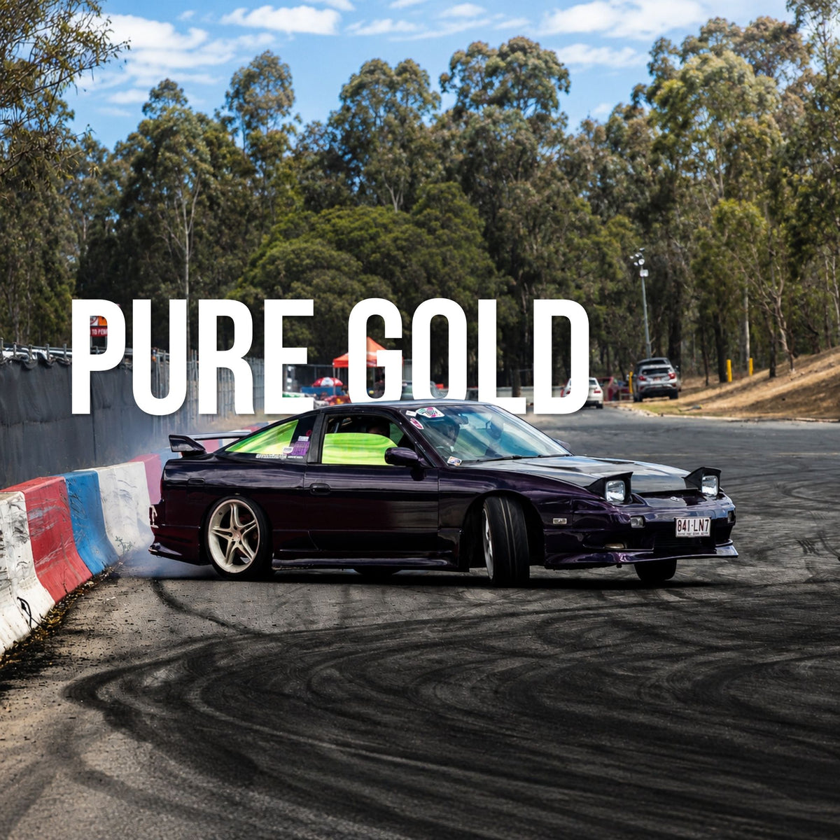 A dark purple Nissan Silvia S15 drift car in a pure gold window tint with a bright green interior and gold wheels, shown on a racetrack with tire marks. Large white text overlay reads 'PURE GOLD'.